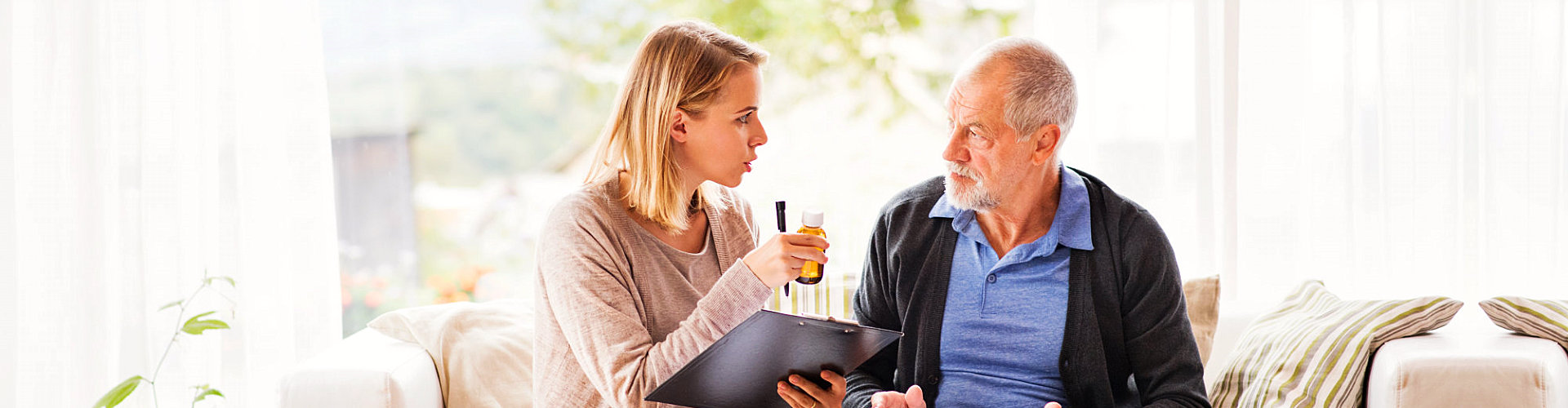 woman reminding senior man about his medication